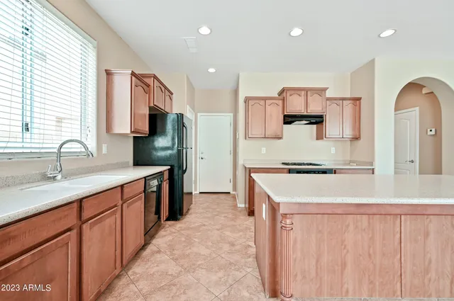 a kitchen with a sink stove and refrigerator