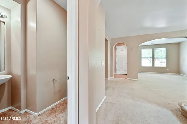 a view of an empty room with windows and closet