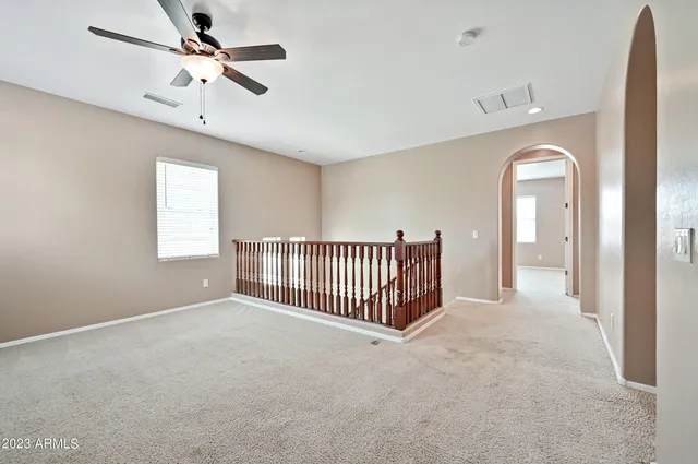 a view of a livingroom with a ceiling fan and window