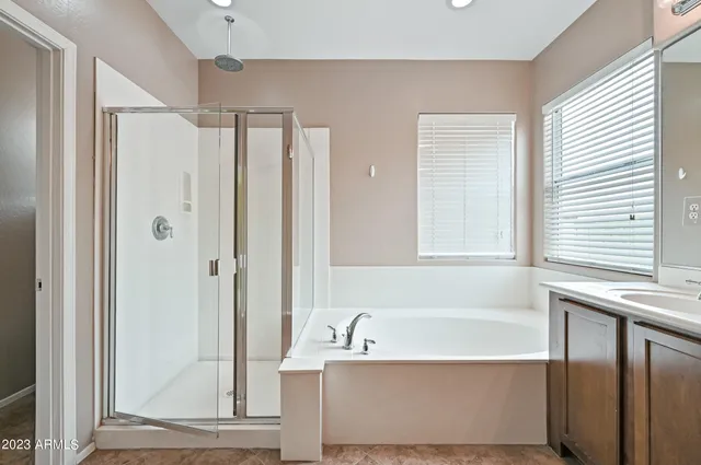 a bathroom with a bathtub and a shower