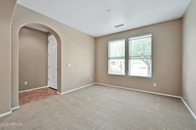 an empty room with windows and closet