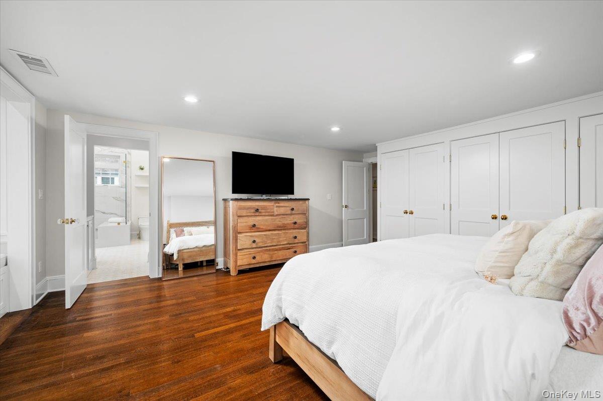 19 Nassau Road Larchmont, NY 10538 - Photo 16 of 40 a spacious bedroom with a bed and a television