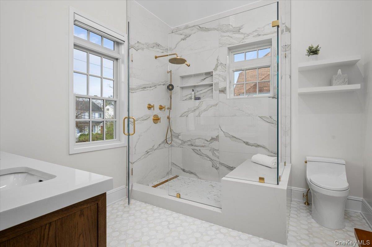 19 Nassau Road Larchmont, NY 10538 - Photo 19 of 40 a bathroom with a bathtub shower sink mirror and toilet