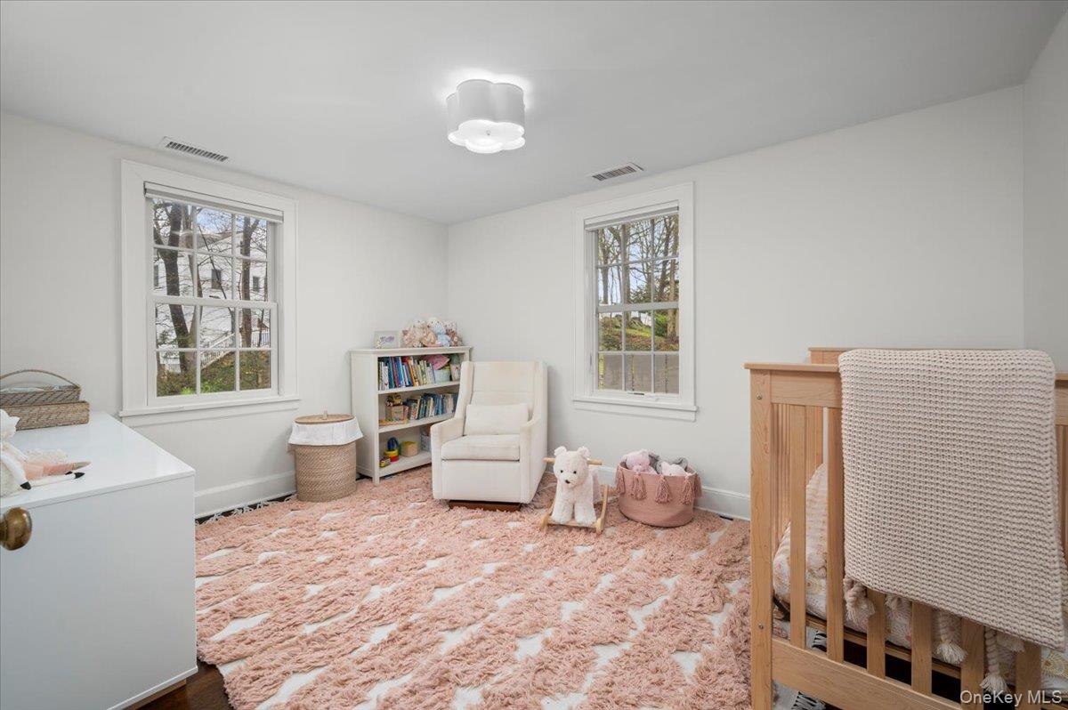 19 Nassau Road Larchmont, NY 10538 - Photo 22 of 40 a bedroom with a bed and wooden floor