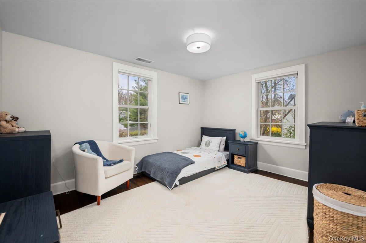 19 Nassau Road Larchmont, NY 10538 - Photo 23 of 40 a bedroom with a bed and wooden floor