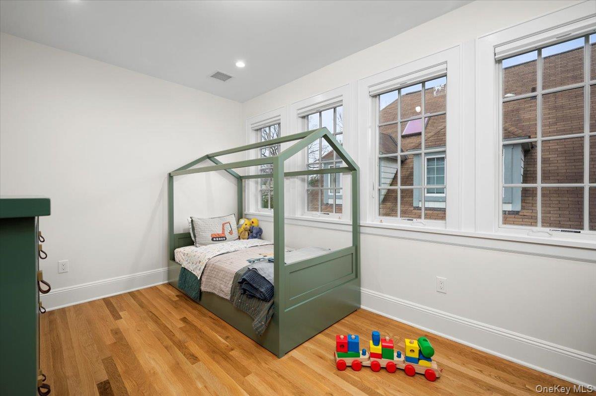 19 Nassau Road Larchmont, NY 10538 - Photo 25 of 40 a bedroom with bed and a window
