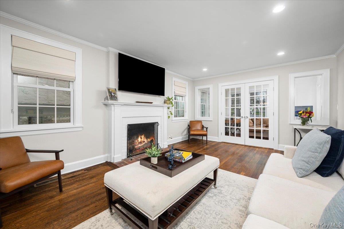 19 Nassau Road Larchmont, NY 10538 - Photo 4 of 40 a living room with furniture a flat screen tv and a fireplace