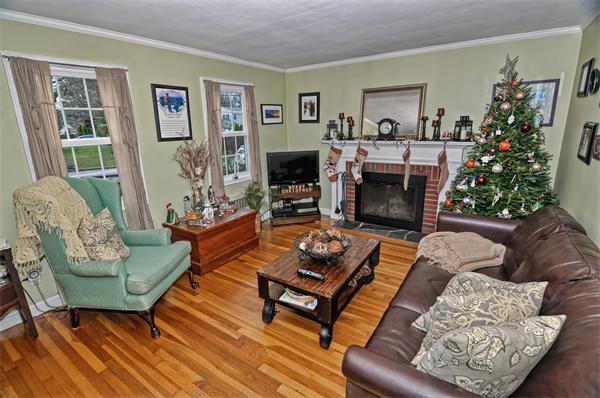 22 Louise Street Canton, MA 02021 - Photo 5 of 26 a living room with furniture a flat screen tv and a fireplace