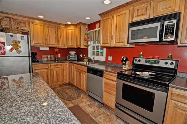 22 Louise Street Canton, MA 02021 - Photo 9 of 26 a kitchen with stainless steel appliances granite countertop a stove a sink and a microwave