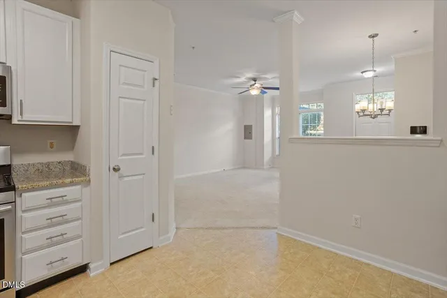 an empty room with cabinet and wooden floor