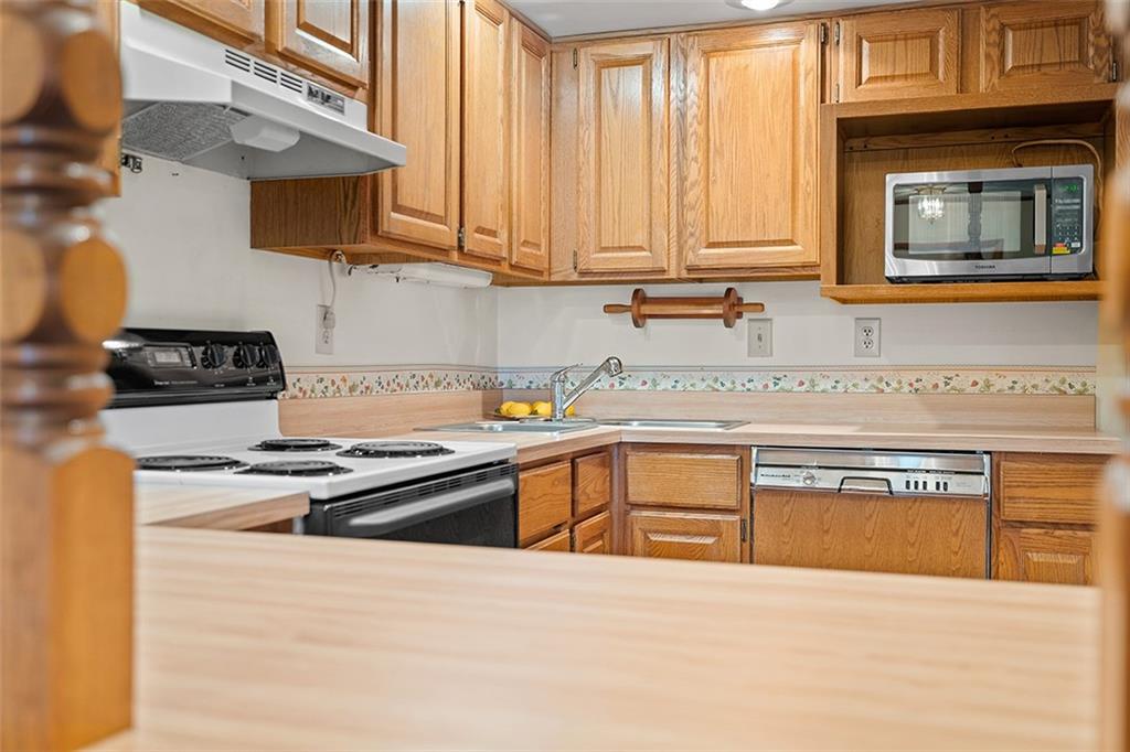 105 Teakwood Road Butler, PA 16001 - Photo 11 of 22 a kitchen with stainless steel appliances granite countertop a stove and a sink