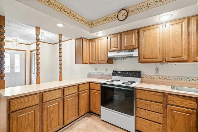 a kitchen with stainless steel appliances granite countertop a stove and a sink