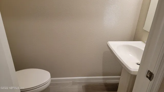 a bathroom with a toilet and sink