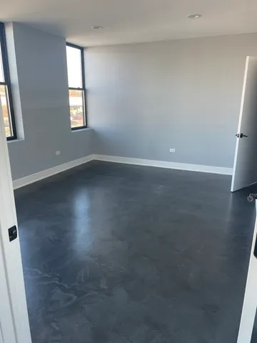 an empty room with windows and closet