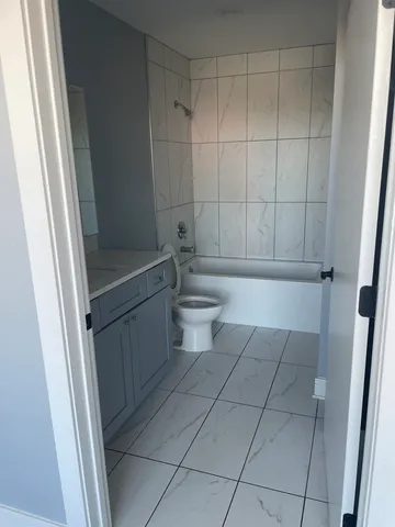 a bathroom with a bathtub and toilet