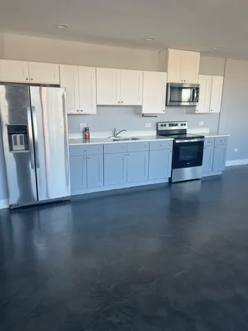 a kitchen with stainless steel appliances wooden cabinets and a sink