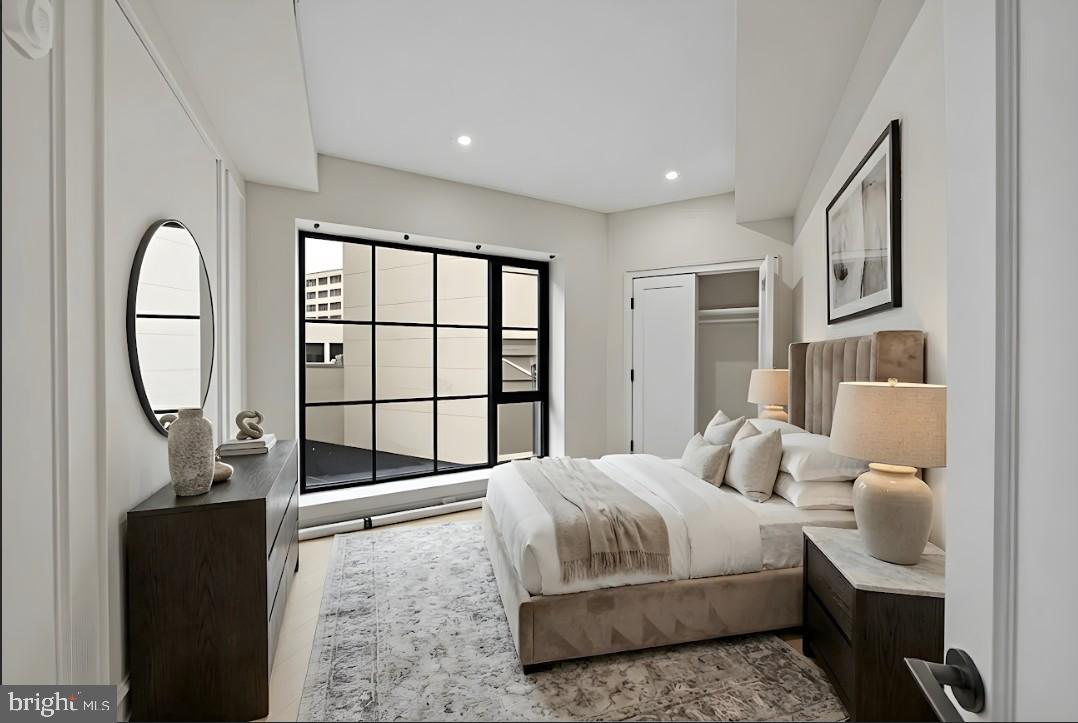 2121 Ward Place Northwest, Unit 401 Washington, DC 20037 - Photo 1 of 21 a bedroom with a bed a mirror and a large window