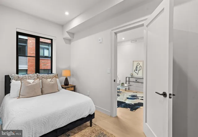 a bedroom with a bed and a mirror