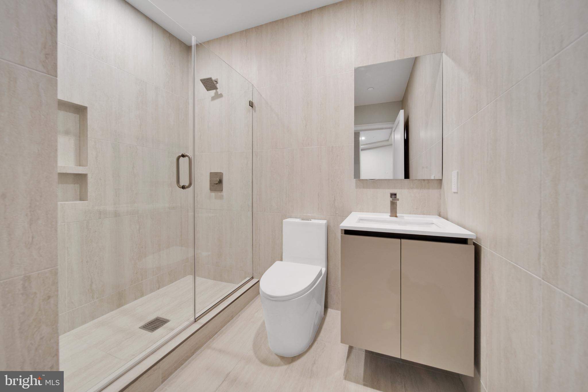 2121 Ward Place Northwest, Unit 401 Washington, DC 20037 - Photo 15 of 21 a bathroom with a shower toilet and sink