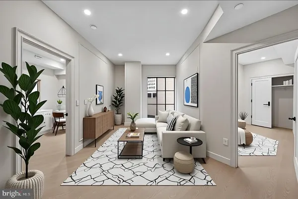 a living room with furniture and a potted plant