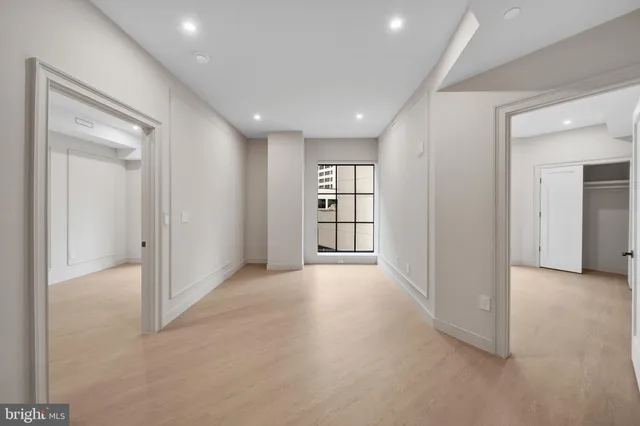 an empty room with windows and closet