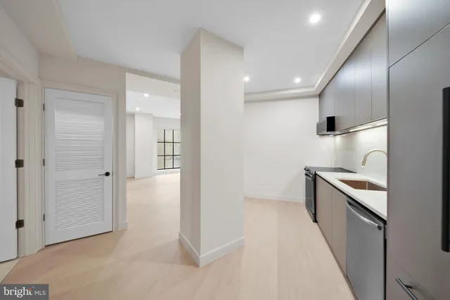 a view of a kitchen with a sink and a stove top oven
