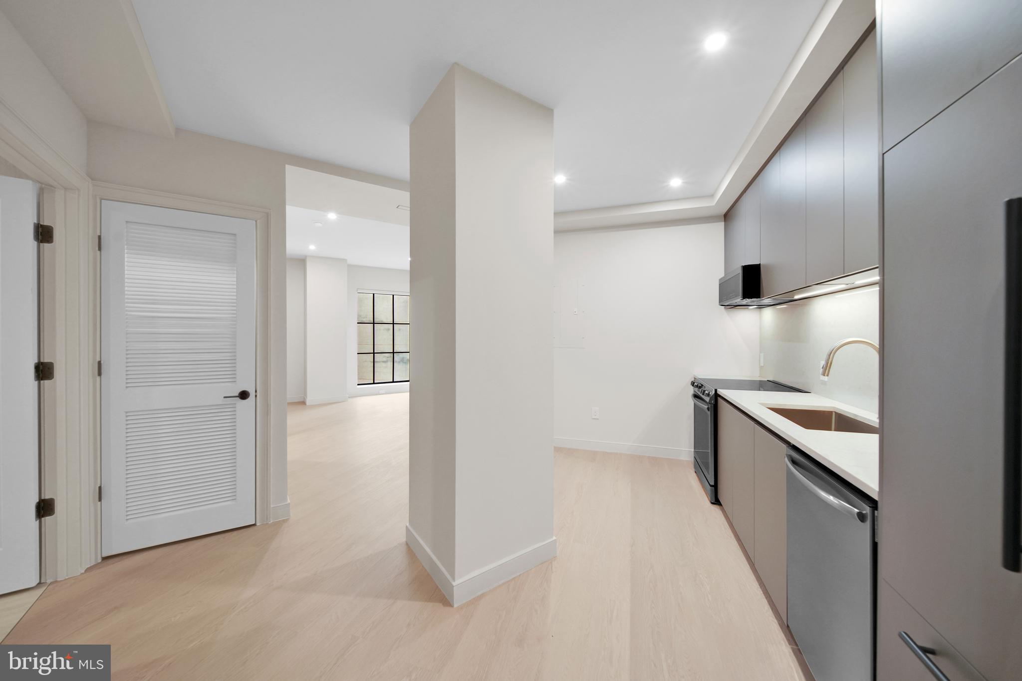 2121 Ward Place Northwest, Unit 401 Washington, DC 20037 - Photo 5 of 21 a view of a kitchen with a sink and a stove top oven