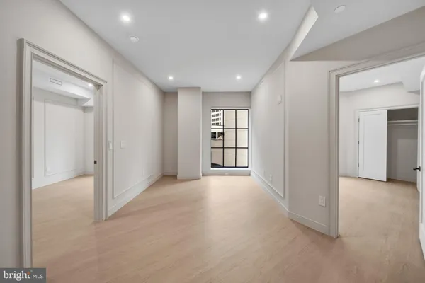 an empty room with windows and closet