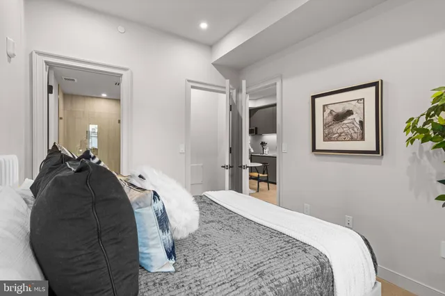 a bedroom with a bed and a painting on the wall