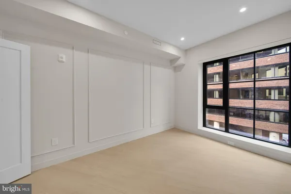 a view of an empty room with glass door