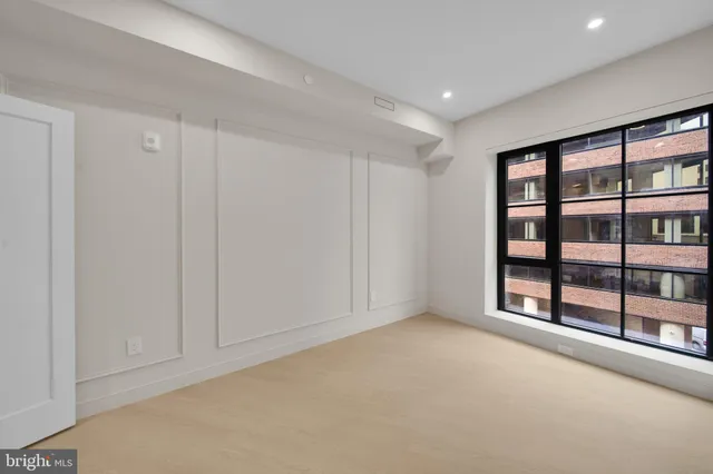 a view of an empty room with glass door