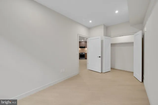 a view of hallway with a window and wooden floor