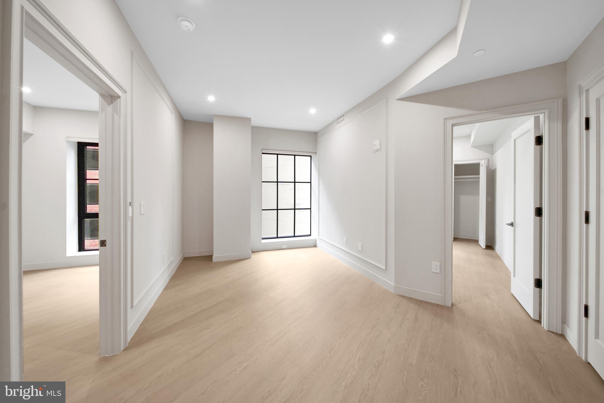 2121 Ward Place Northwest, Unit 401 Washington, DC 20037 - Photo 10 of 21 a view of hallway with a window and wooden floor