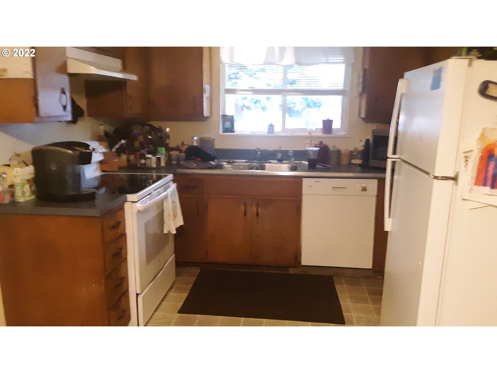 210 North 38th Place Springfield, OR 97478 - Photo 7 of 20 a kitchen with a refrigerator and a sink