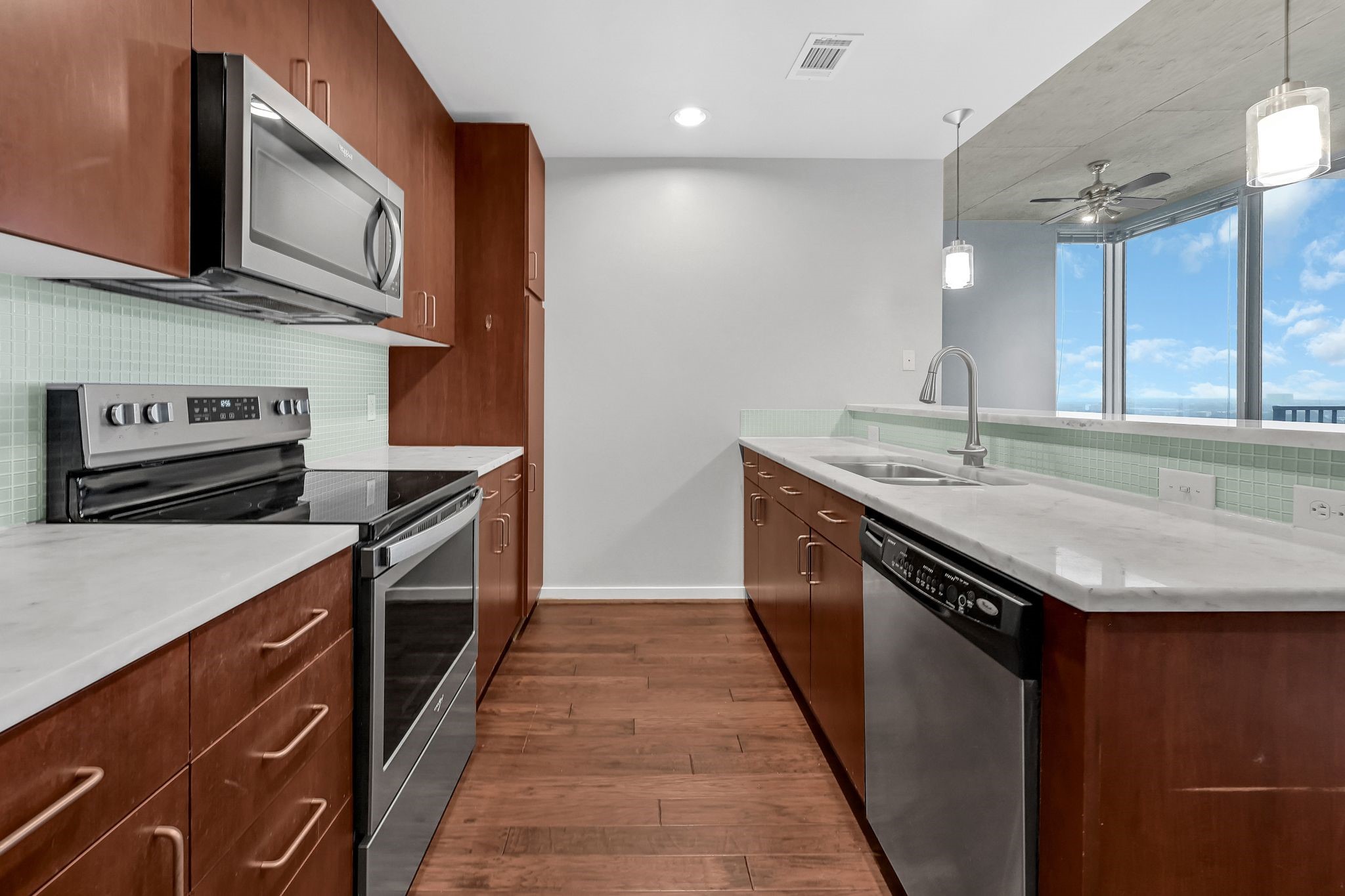 5925 Almeda Road, Unit 11501 Houston, TX 77004 - Photo 5 of 30 a kitchen with stainless steel appliances granite countertop a sink a stove and a microwave