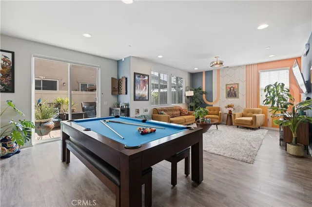 a living room with furniture pool table and a table