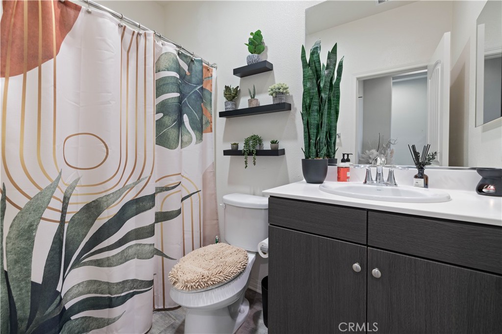 22088 Windham Way Saugus, CA 91350 - Photo 20 of 62 a bathroom with a sink mirror vanity and toilet
