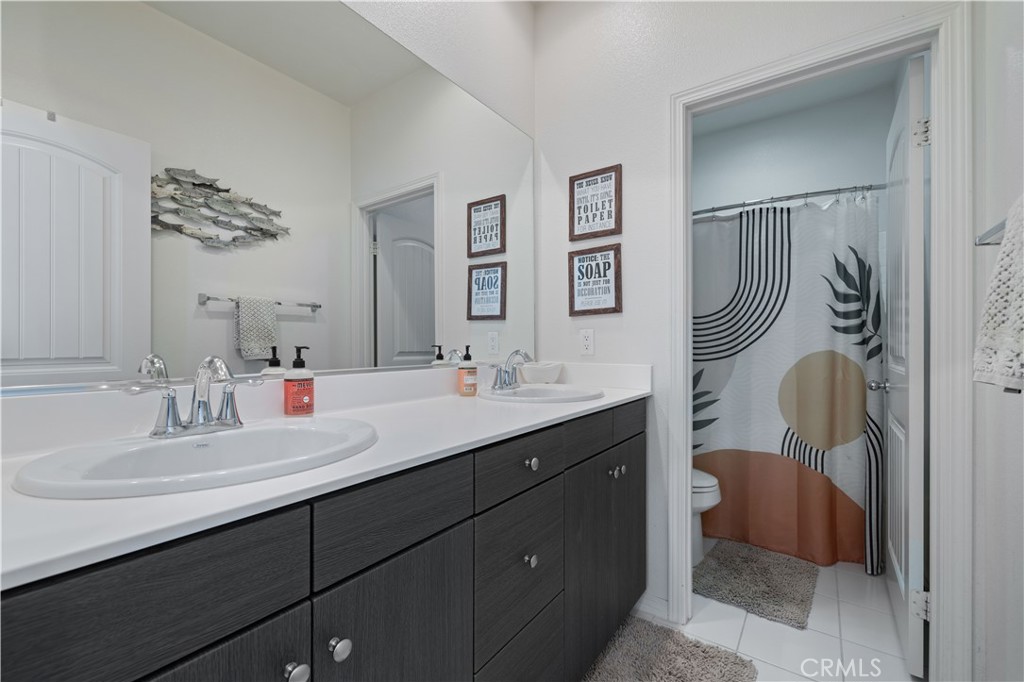22088 Windham Way Saugus, CA 91350 - Photo 24 of 62 a bathroom with a sink vanity mirror and toilet