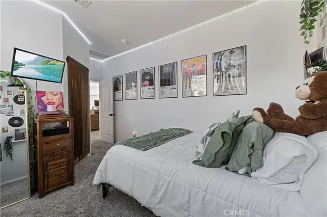 a bedroom with a bed and a dresser