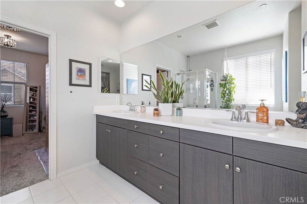 22088 Windham Way Saugus, CA 91350 - Photo 36 of 62 a bathroom with a sink double vanity granite and a mirror