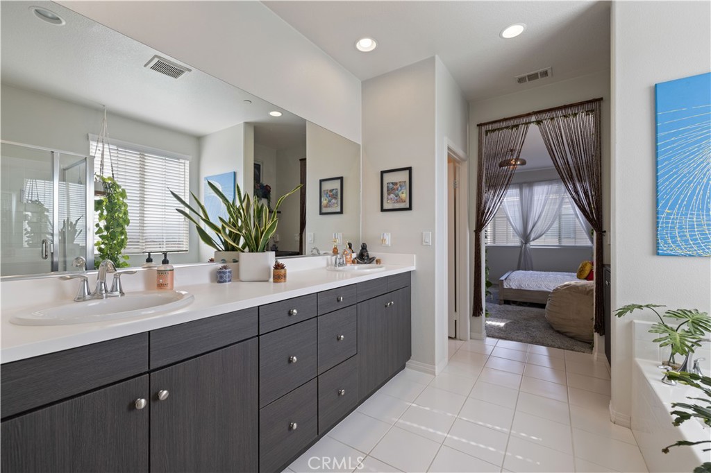 22088 Windham Way Saugus, CA 91350 - Photo 39 of 62 a en suite bathroom with a double vanity sink and a mirror