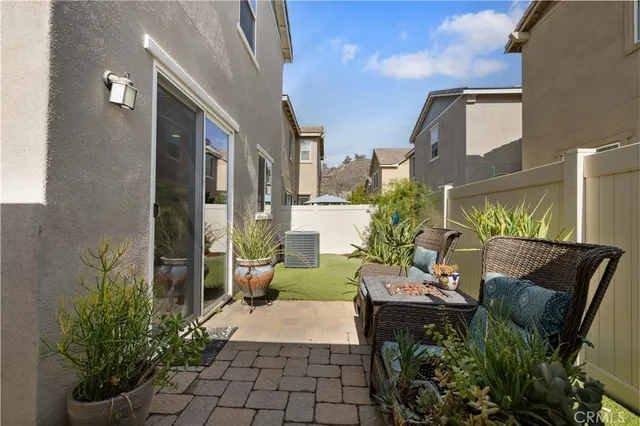 a view of a house with backyard and sitting area