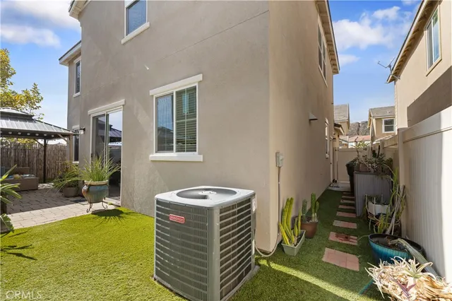 a backyard of a house with yard and outdoor seating
