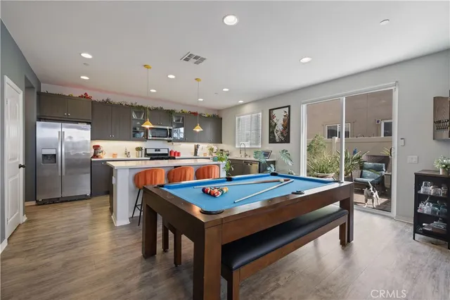 a living room with stainless steel appliances kitchen island granite countertop furniture and a kitchen view