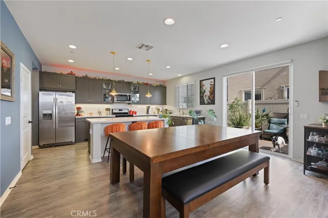 a living room with furniture a flat screen tv and a table
