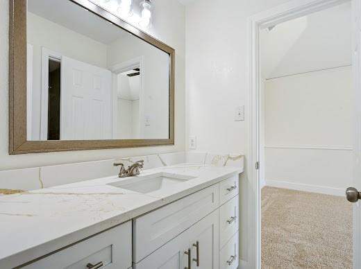 5034 West Fall Drive Midlothian, TX 76065 - Photo 26 of 40 Vanity featuring a white quartz-finish countertop with an integrated sink and brushed nickel faucet