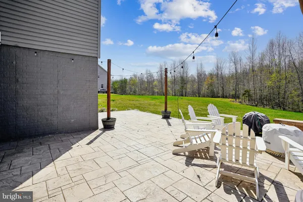 a view of a patio with a table chairs and backyard