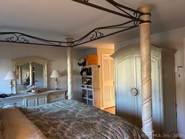 24 Colonial Drive Waterford, CT 06385 - Photo 15 of 25 a bedroom with a bed and a mirror