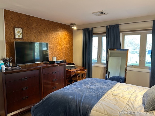 24 Colonial Drive Waterford, CT 06385 - Photo 18 of 25 a bedroom with a bed and a flat screen tv