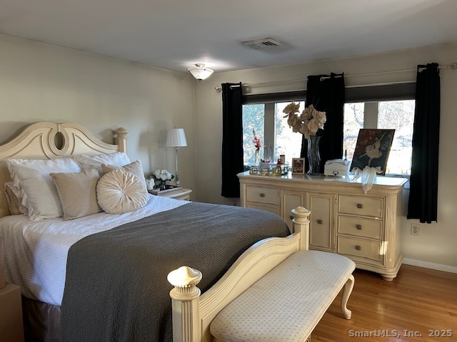 24 Colonial Drive Waterford, CT 06385 - Photo 19 of 25 a bedroom with a bed and large windows